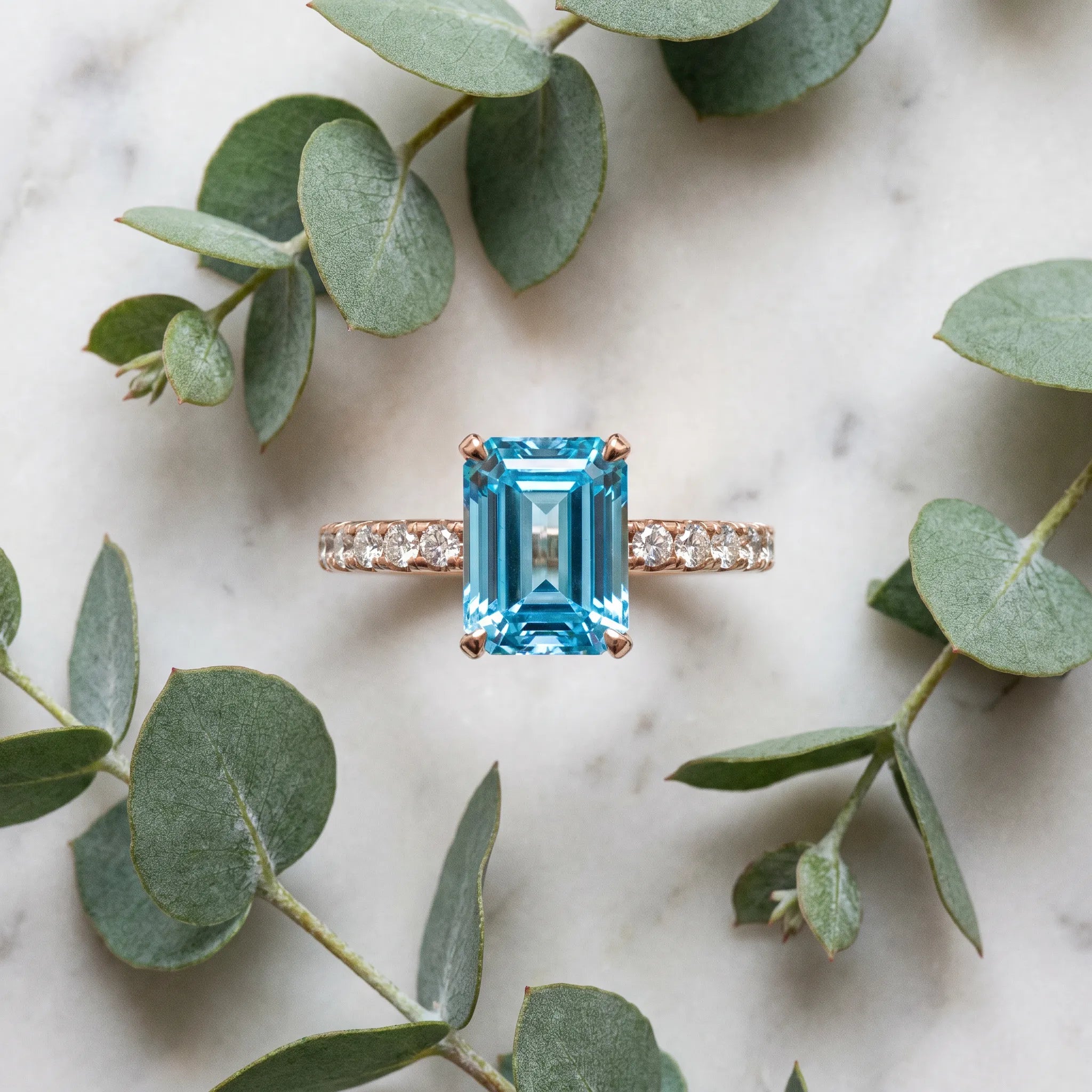 Rose gold Emerald Cut Blue Topaz Solitaire Ring with Round  Pavé Band and Four-Prong Setting_57
