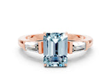 Rose gold Emerald Cut Cut Diamond Ring with Tapered Baguette Side Stones in Four-Prong Setting