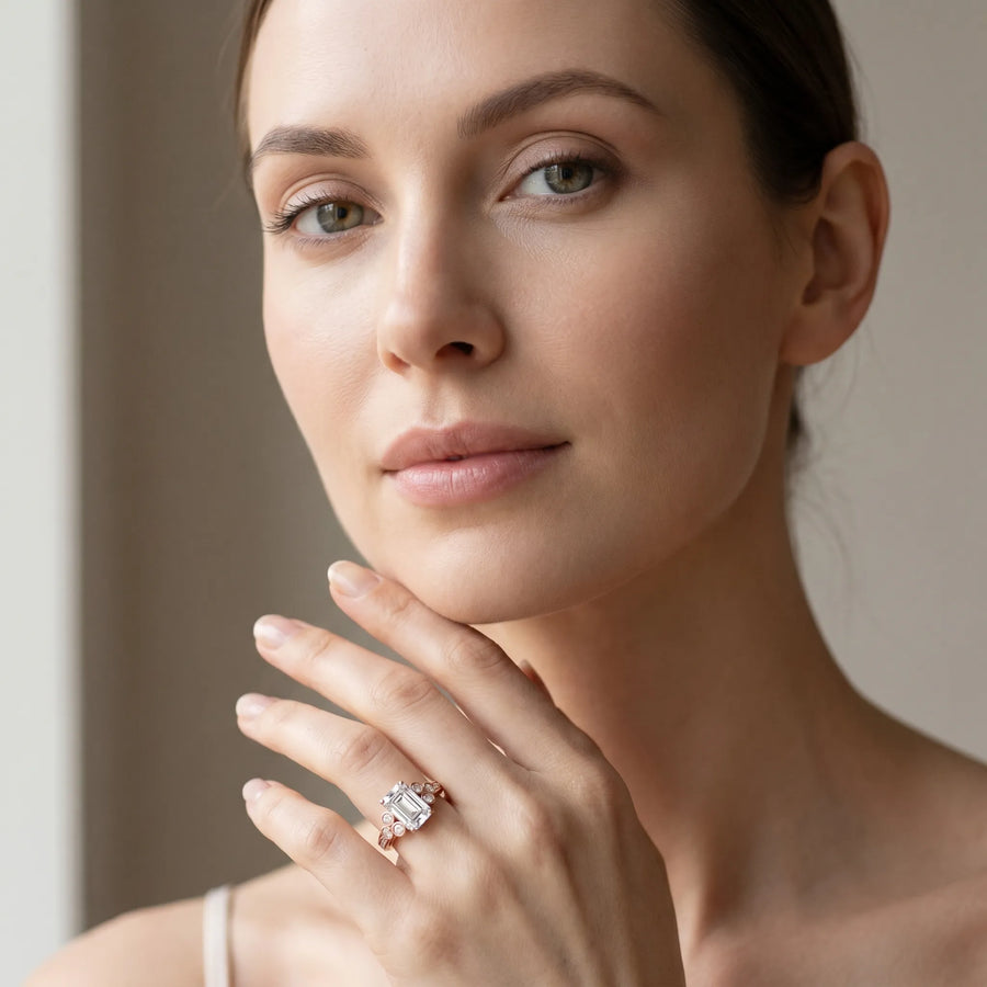 Rose gold Emerald Cut Diamond Engagement Ring with Bezel Set Round Side Stones and Prong Setting