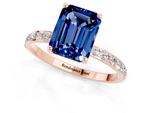 Rose gold Emerald Cut Blue Sapphire Solitaire Ring with Round Pavé Shoulders and Prong Setting