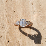 Rose gold Emerald Cut Diamond Three-Stone Ring with Round Side Stones and Pavé Band_15