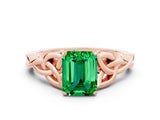 Rose gold Emerald Cut Emerald Solitaire Engagement Ring with Celtic Knot Band and Four-Prong Setting