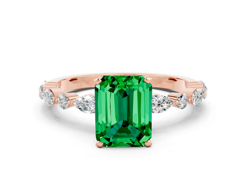 Rose gold Emerald Cut Emerald Solitaire with Side Stones on a Pavé Band and Four-Prong Setting
