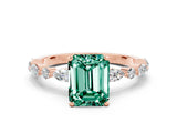 Rose gold Emerald Cut Green Sapphire Solitaire with Side Stones on a Pavé Band and Four-Prong Setting
