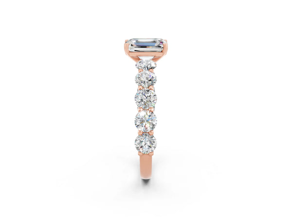 Rose gold Emerald Cut Moissanite Prong Setting with Side Stones on a Pave Band