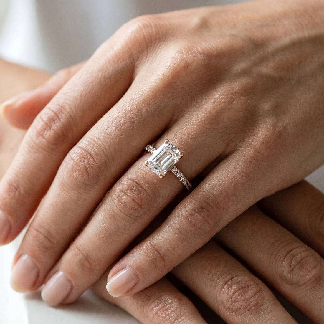 Rose gold Emerald Cut Moissanite Solitaire Ring with Round  Pavé Band and Four-Prong Setting