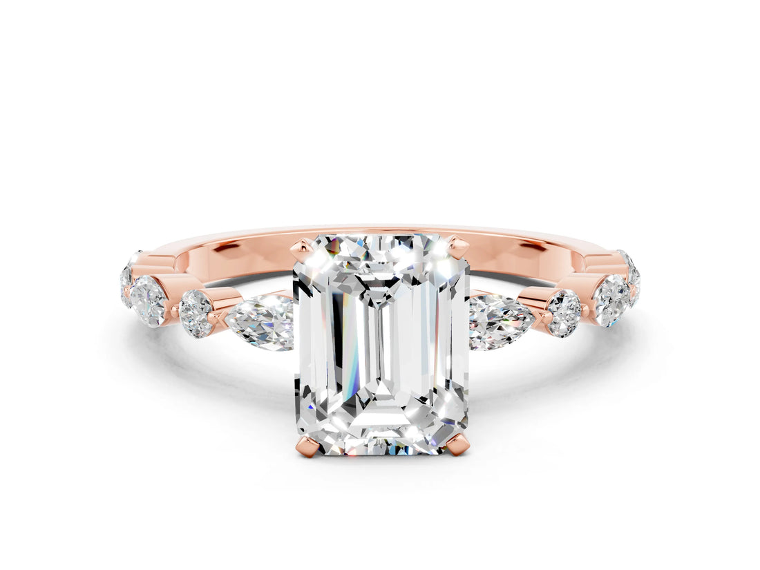 Rose gold Emerald Cut Moissanite Solitaire with Side Stones on a Pavé Band and Four-Prong Setting