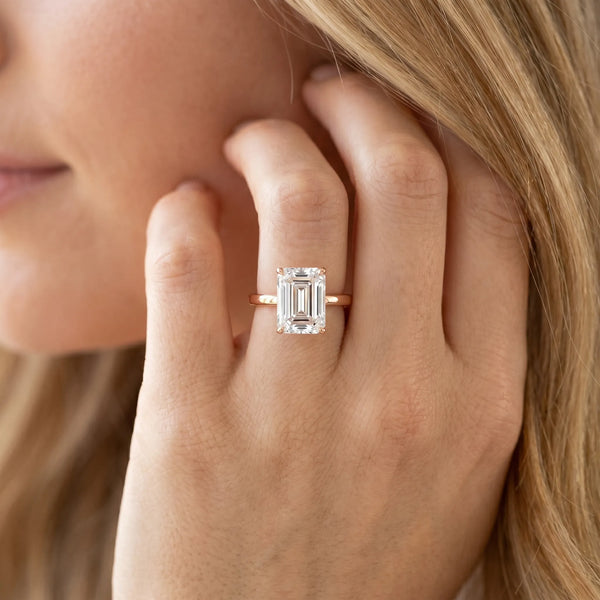 Rose gold Emerald Cut Solitaire Engagement Ring with Four-Prong Setting on a Classic Band