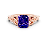 Rose gold Emerald Cut Tanzanite Solitaire Engagement Ring with Celtic Knot Band and Four-Prong Setting