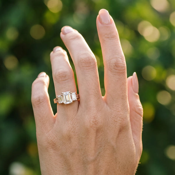 Rose gold Emerald Diamond Three-Stone Ring with Prong Setting and Textured Band