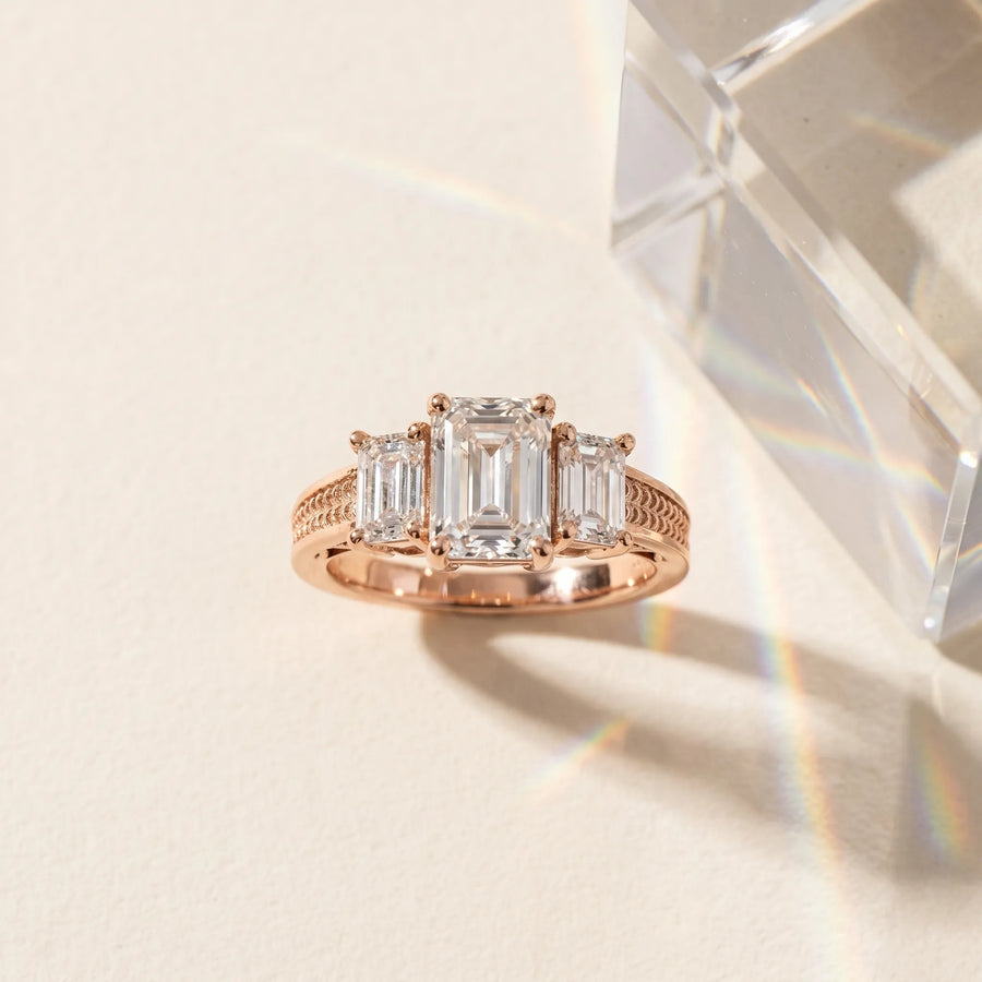 Rose gold Emerald Diamond Three-Stone Ring with Prong Setting and Textured Band