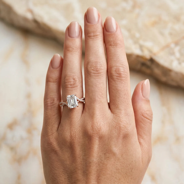 Rose gold Emerald Solitaire Twist Band with Channel-Set Diamonds and Four-Prong Setting