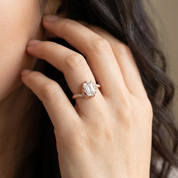 Rose gold Emerald Solitaire Twist Band with Channel-Set Diamonds and Four-Prong Setting