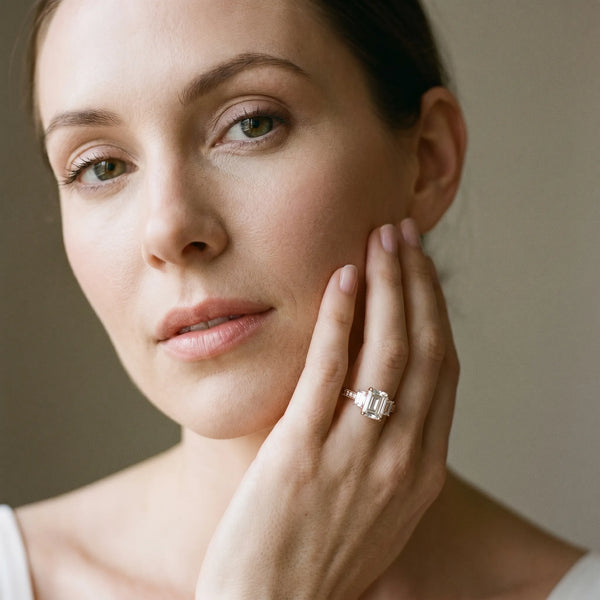 Rose gold Emerald Three-Stone Diamond Ring with Pavé Band and Four-Prong Setting