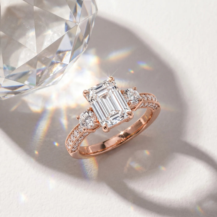 Rose gold Emerald Three-Stone Diamond Ring with Pavé Band and Four-Prong Setting