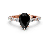 Rose gold Fancy Black Pear Cut Diamond Solitaire with Side Stones on a Pavé Band and Four-Prong Setting