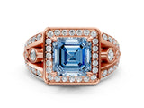 Rose gold Fancy Blue Asscher Cut Diamond Halo Ring with Split Shank and Bezel Accents and Four-Prong Setting