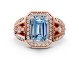 Rose gold Fancy Blue Emerald Cut Diamond Halo Ring with Split Shank and Bezel Accents and Four-Prong Setting