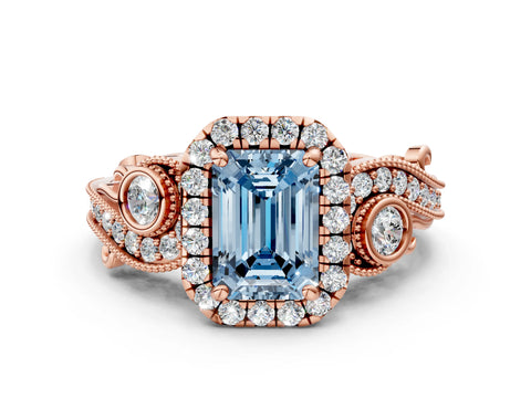 Rose gold Fancy Blue Emerald Cut Halo Diamond Ring with Milgrain and Bezel Accents on a Split Shank Band