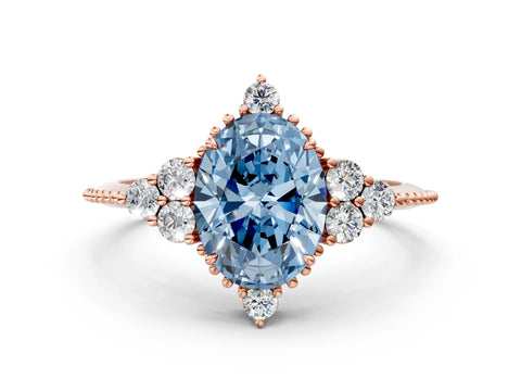 Rose gold Fancy Blue Oval Cut Brilliant Diamond with Cluster Setting on a Beaded Band and Four-Prong Setting