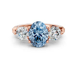 Rose gold Fancy Blue Oval Cut Diamond Three-Stone Ring with Prong Setting and Pavé Band