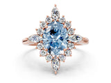 Rose gold Fancy Blue Oval Cut Halo Diamond Cluster Ring with Marquise and Round Stones on a White Gold Band with Prong Setting