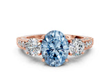 Rose gold Fancy Blue Oval Cut Three-Stone Diamond Ring with Pavé Band and Four-Prong Setting