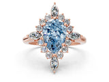 Rose gold Fancy Blue Pear Cut Halo Diamond Cluster Ring with Marquise and Round Stones on a White Gold Band with Prong Setting
