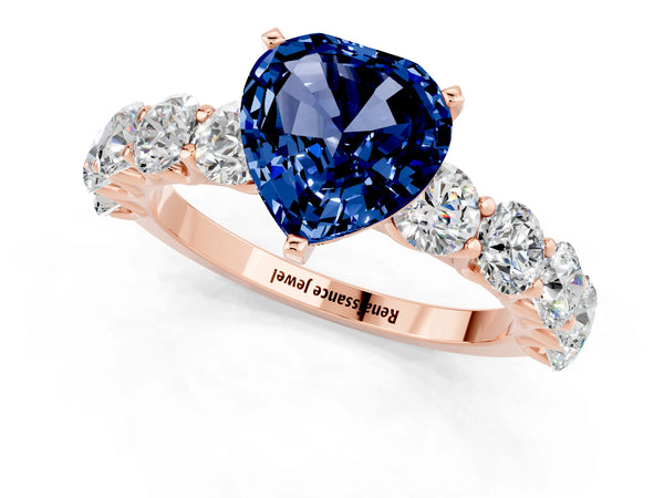 Rose gold Heart Cut Blue Sapphire Prong Setting with Side Stones on a Pave Band