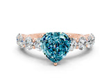 Rose gold Heart Cut Blue Topaz Prong Setting with Side Stones on a Pave Band