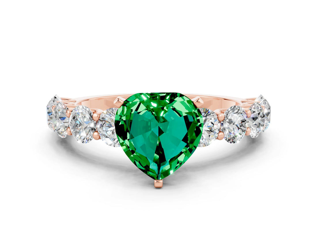 Rose gold Heart Cut Emerald Prong Setting with Side Stones on a Pave Band