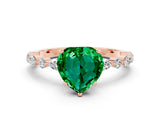 Rose gold Heart Cut Emerald Solitaire with Side Stones on a Pavé Band and Four-Prong Setting