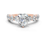 Rose gold Heart Cut Moissanite Prong Setting with Side Stones on a Pave Band