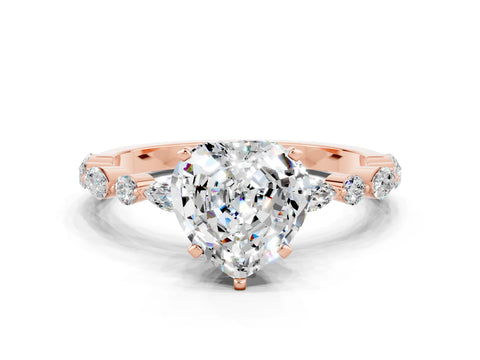 Rose gold Heart Cut Moissanite Solitaire with Side Stones on a Pavé Band and Four-Prong Setting