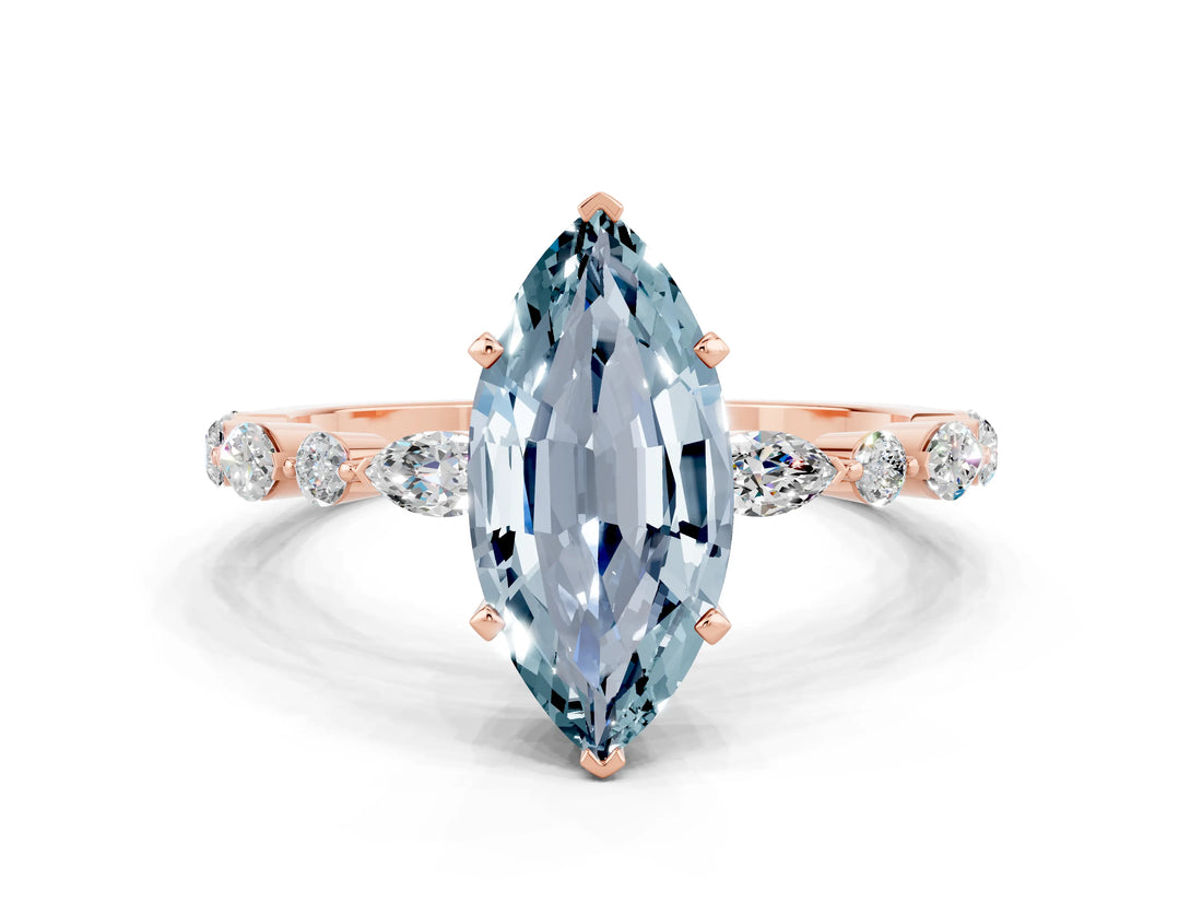 Rose gold Marquise Cut Aquamarine Solitaire with Side Stones on a Pavé Band and Four-Prong Setting