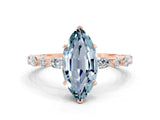 Rose gold Marquise Cut Aquamarine Solitaire with Side Stones on a Pavé Band and Four-Prong Setting