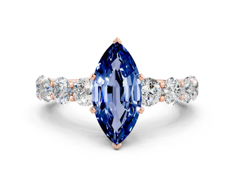 Rose gold Marquise Cut Blue Sapphire Prong Setting with Side Stones on a Pave Band
