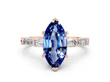 Rose gold Marquise Cut Blue Sapphire Solitaire with Side Baguettes and Channel Set Band