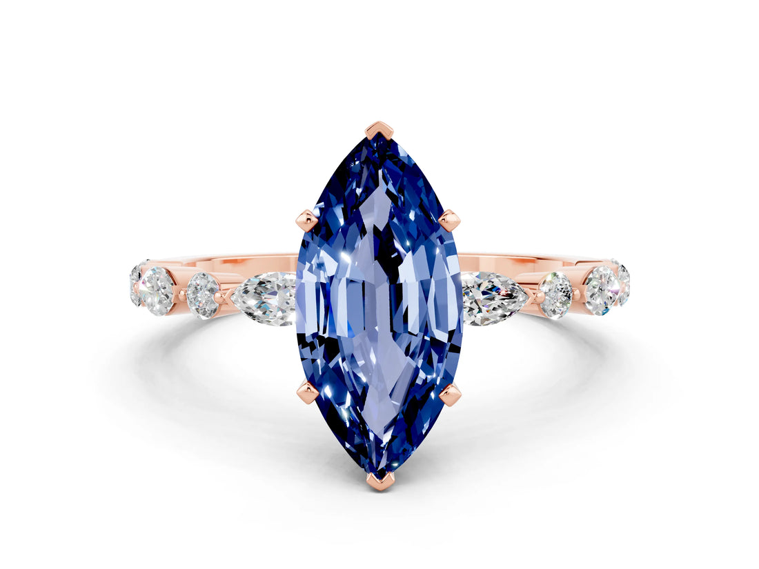 Rose gold Marquise Cut Blue Sapphire Solitaire with Side Stones on a Pavé Band and Four-Prong Setting