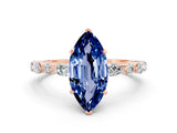Rose gold Marquise Cut Blue Sapphire Solitaire with Side Stones on a Pavé Band and Four-Prong Setting