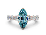 Rose gold Marquise Cut Blue Topaz Prong Setting with Side Stones on a Pave Band