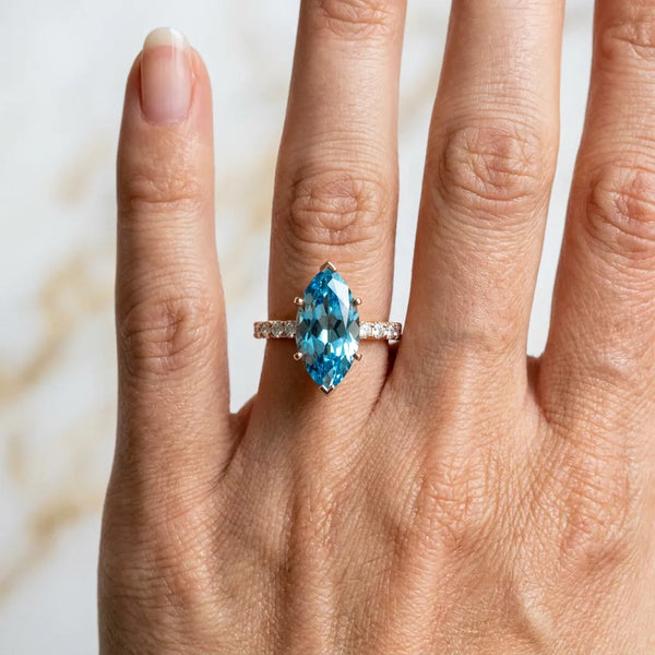 Rose gold Marquise Cut Blue Topaz Solitaire Ring with Round Pavé Band and Four-Prong Setting