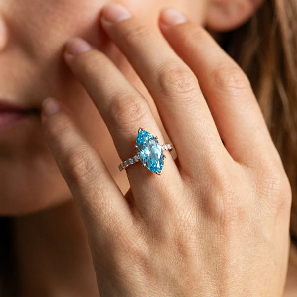 Rose gold Marquise Cut Blue Topaz Solitaire Ring with Round Pavé Band and Four-Prong Setting
