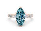 Rose gold Marquise Cut Blue Topaz Solitaire with Side Baguettes and Channel Set Band