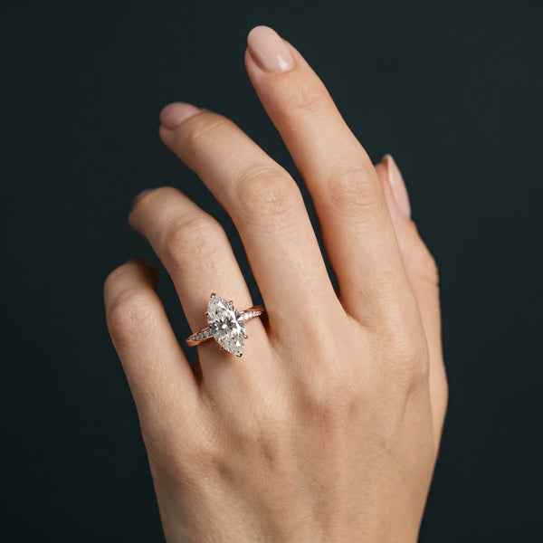 Rose gold Marquise Cut Diamond Engagement Ring with Side Stone Accents and Four-Prong Setting