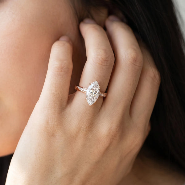Rose gold Marquise Cut Diamond Engagement Ring with Side Stone Accents and Four-Prong Setting