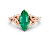 Rose gold Marquise Cut Emerald Solitaire Engagement Ring with Celtic Knot Band and Four-Prong Setting
