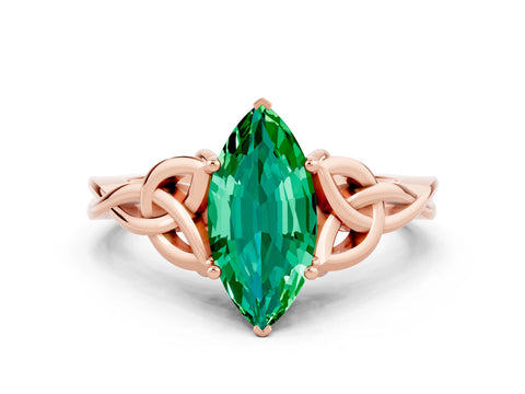 Rose gold Marquise Cut Emerald Solitaire Engagement Ring with Celtic Knot Band and Four-Prong Setting
