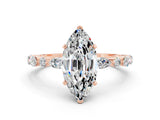 Rose gold Marquise Cut Moissanite Solitaire with Side Stones on a Pavé Band and Four-Prong Setting