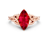 Rose gold Marquise Cut Ruby Solitaire Engagement Ring with Celtic Knot Band and Four-Prong Setting